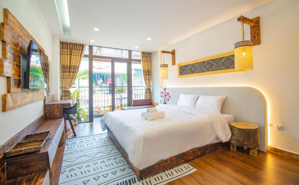a bedroom with a large bed and a large window at Mimosa Homestay in Hanoi