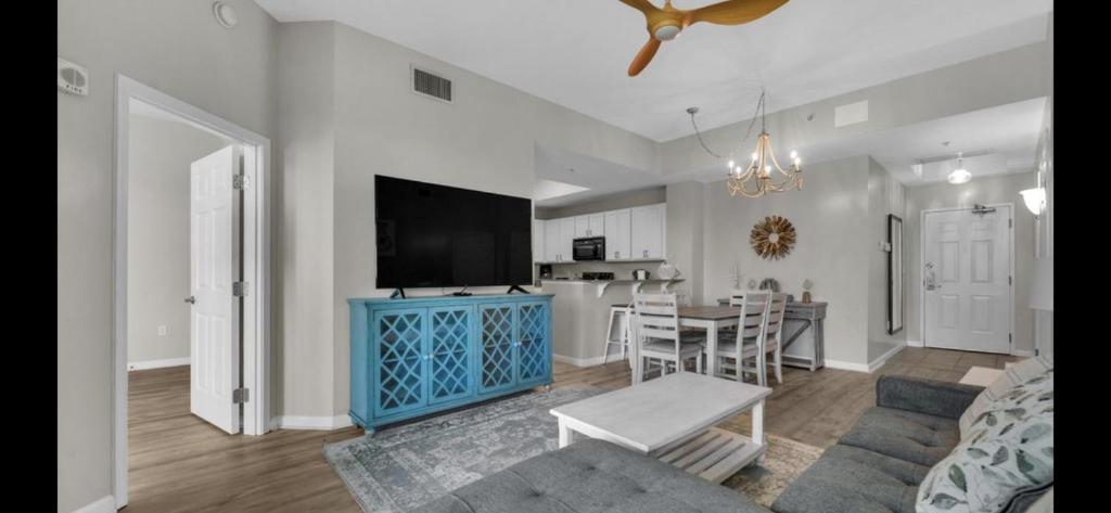 a living room with a blue cabinet and a kitchen at The Palms of Destin-2116 in Destin