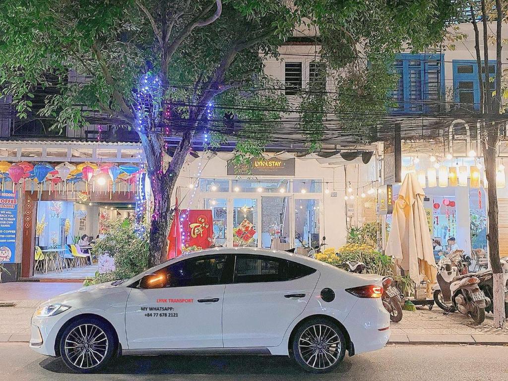 a white car parked in front of a store at Lynk Stay Hoian in Hoi An