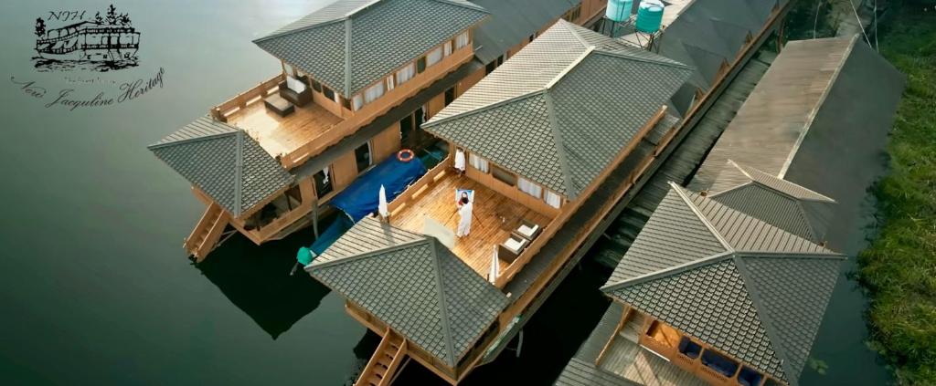 an overhead view of a house on the water at New Jacquline Heritage Houseboats in Srinagar