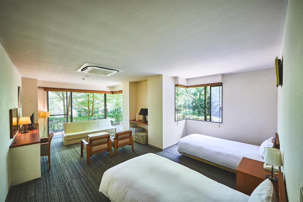Postel nebo postele na pokoji v ubytování Shiki Resort Gora Saika
