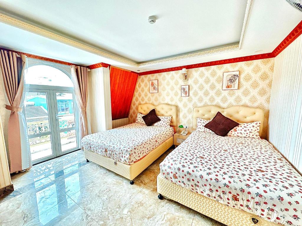 Postel nebo postele na pokoji v ubytování Xing City Hotel Dalat