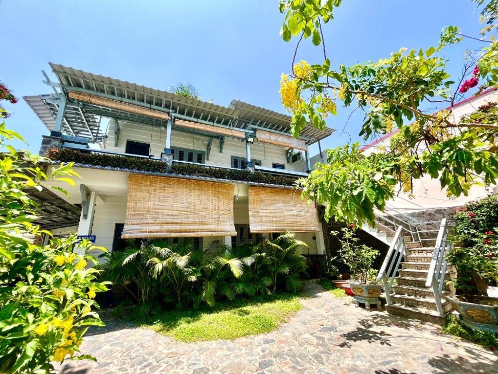 an external view of a house with a staircase at Catsen Bungalows & Pool Phan Thiet in Phan Thiet