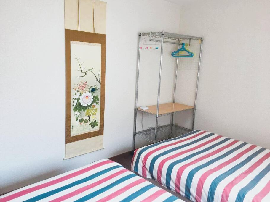 Postel nebo postele na pokoji v ubytování 花跡民宿二号馆独栋整租！市中心 ! 4分钟到难波日本桥！通天阁,天王寺步行圈
