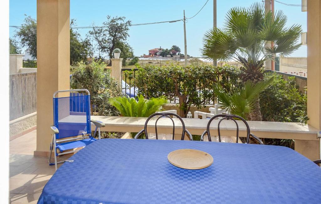 a blue table and chairs with a plate on it at Nice Apartment In Marzamemi in Marzamemi