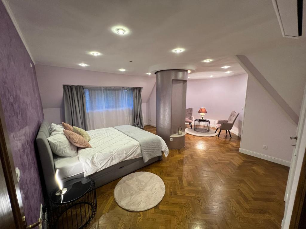 a bedroom with a bed and a table and a chair at Le Joyau de Balmoral in Sart-lez-Spa