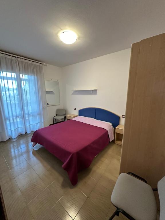 A bed or beds in a room at Residence Beatrice - Agenzia Cocal