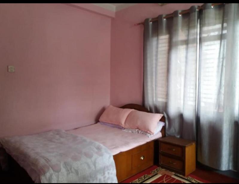 Ένα ή περισσότερα κρεβάτια σε δωμάτιο στο Khadka Niwas