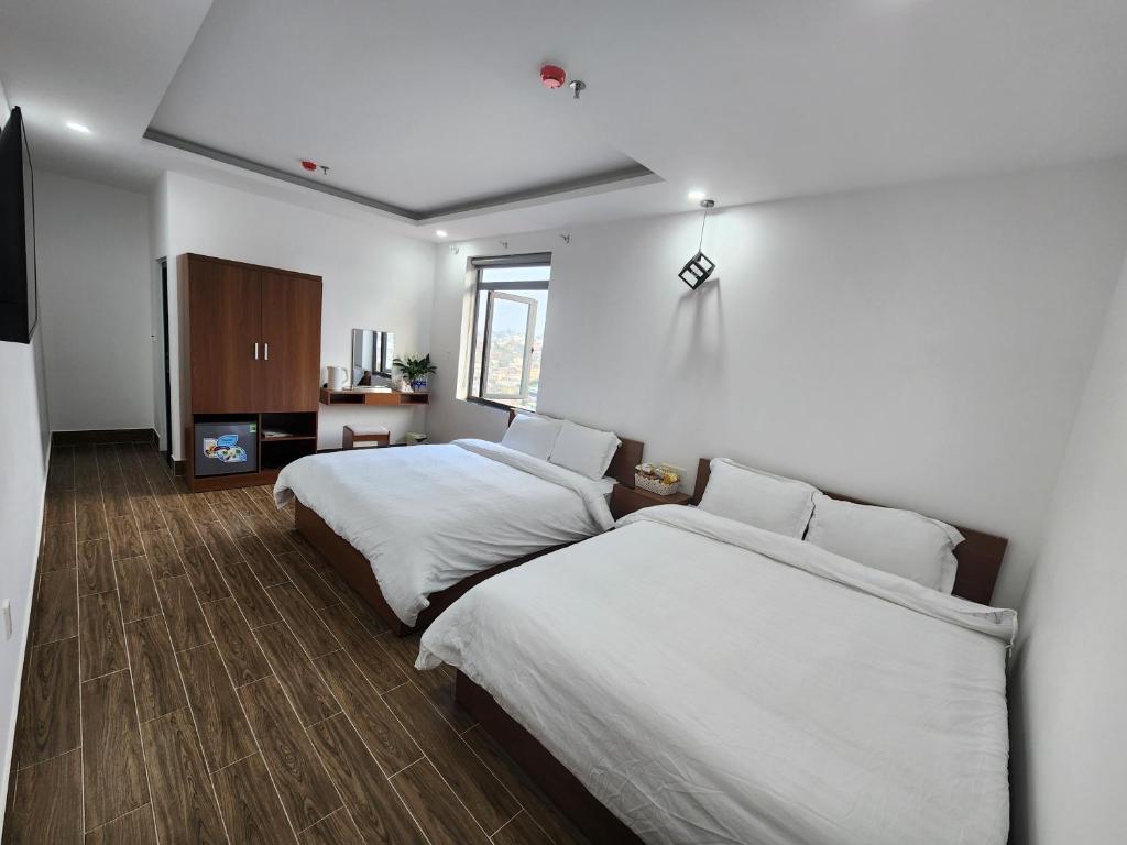 Postel nebo postele na pokoji v ubytování Happy Bun Hotel Da Lat