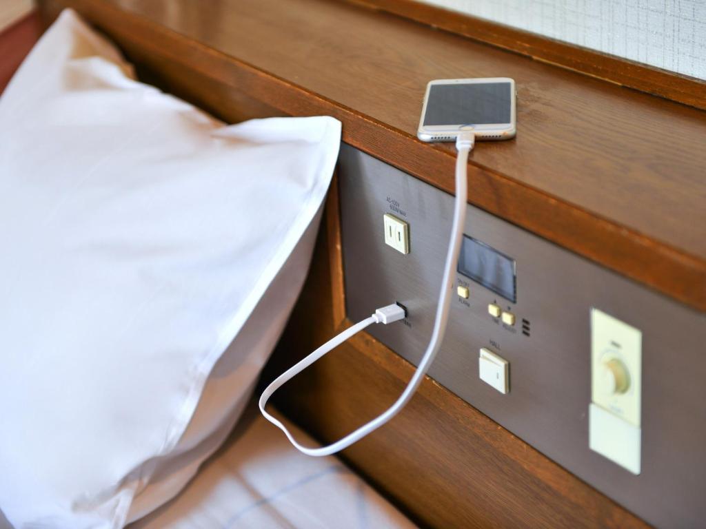 Postel nebo postele na pokoji v ubytování Hotel New Gaea Ube