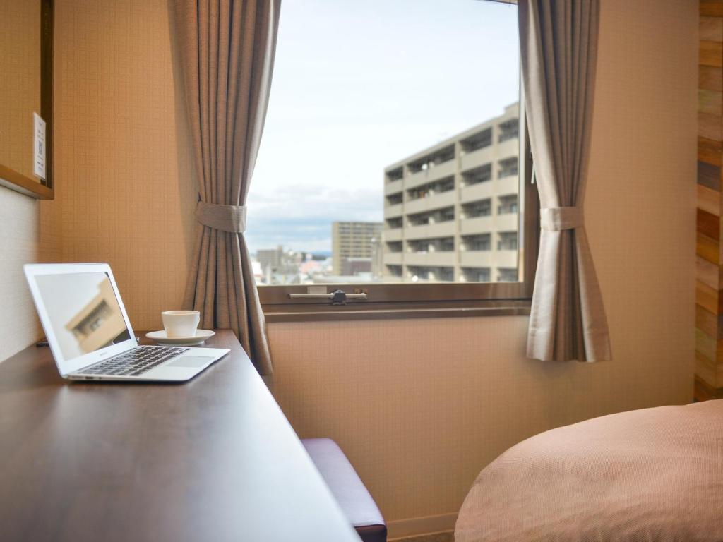 Postel nebo postele na pokoji v ubytování Hotel New Gaea Ube