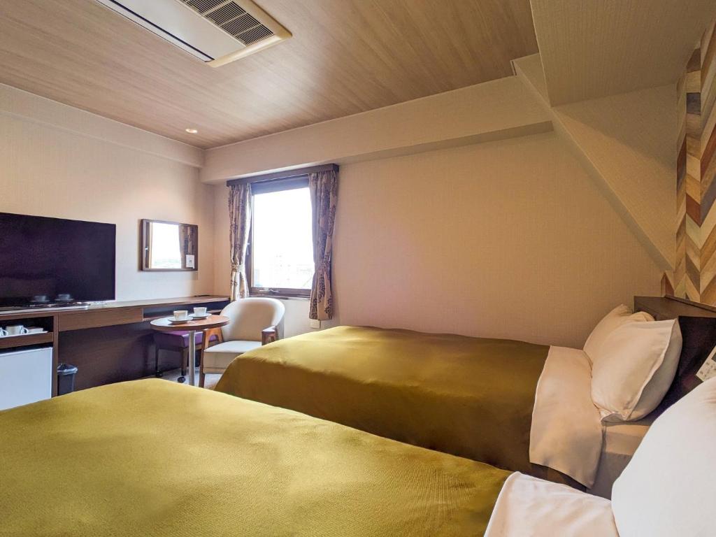 TV a/nebo společenská místnost v ubytování Hotel New Gaea Ube