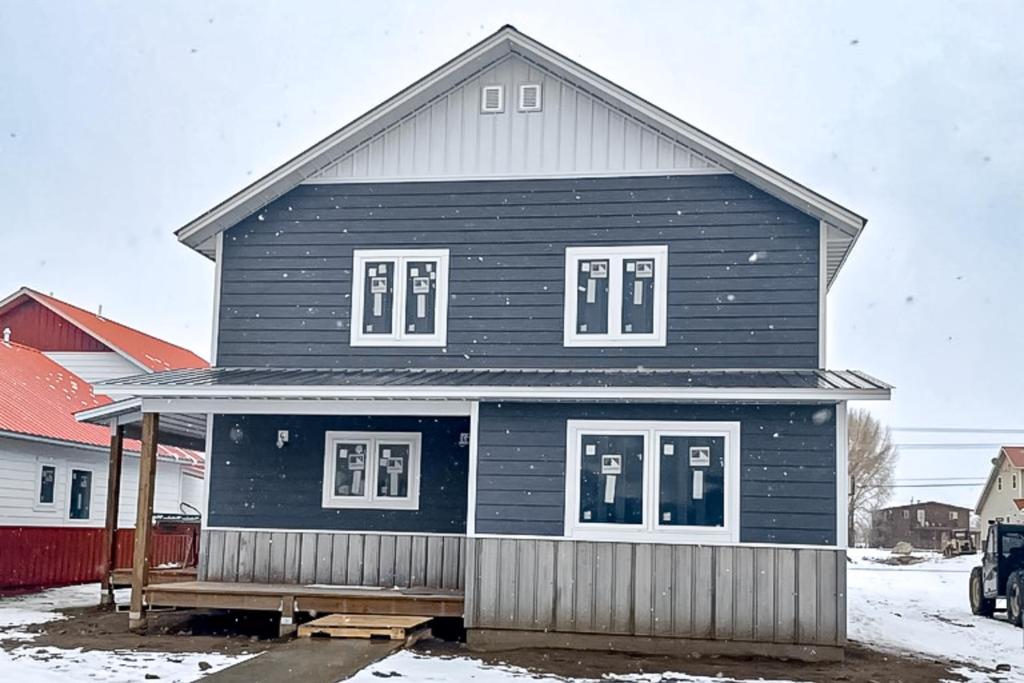 a black house with white windows in the snow at Western Slope Retreat in Gunnison