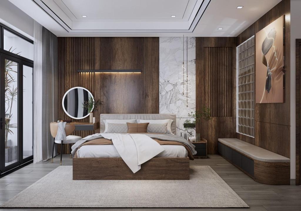 a bedroom with a large bed and a mirror at T&T Luxury Hotel in Quy Nhon