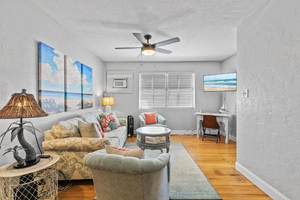 a living room with two couches and a ceiling fan at Flagler Suites 3 in New Smyrna Beach
