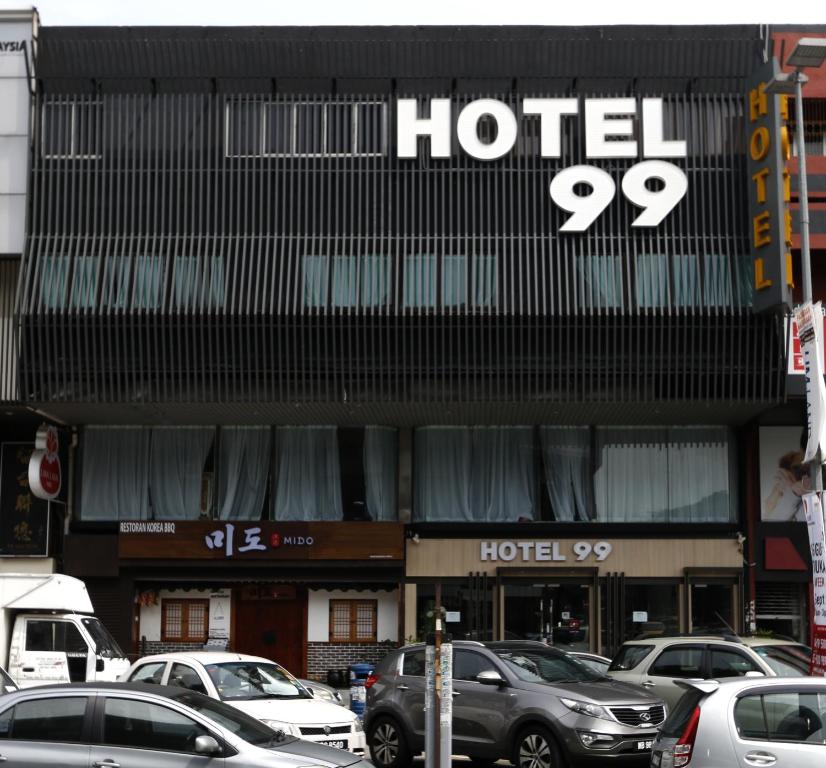a hotel with cars parked in front of it at Hotel 99 SS2 Petaling Jaya in Petaling Jaya