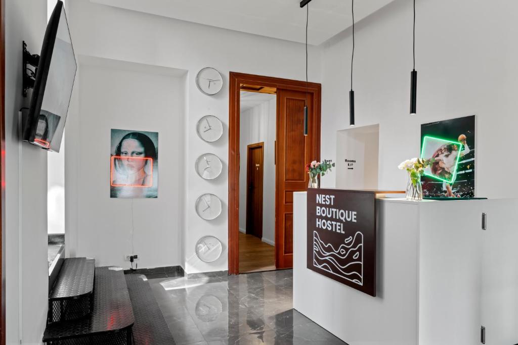 a living room with a sign in front of a door at Nest Boutique Hostel in Bucharest