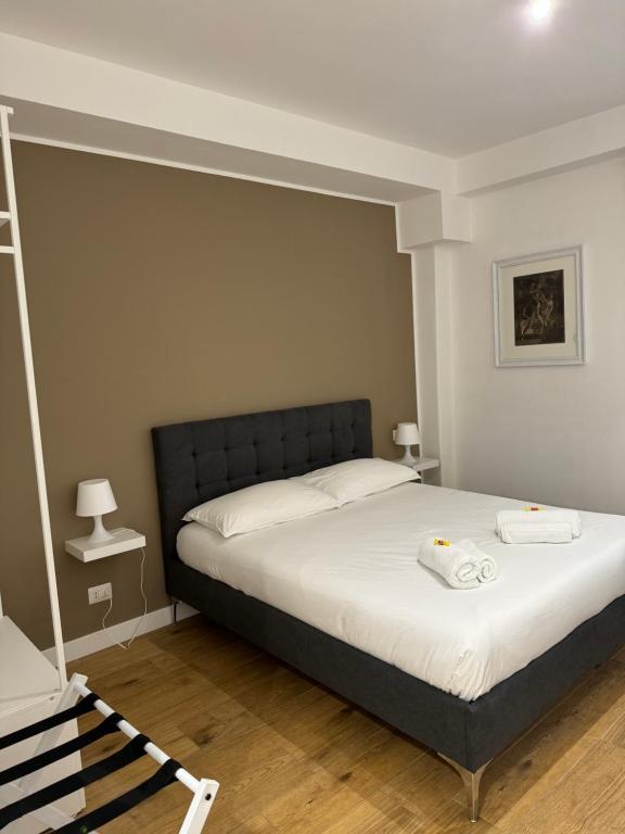 a bedroom with a bed with two towels on it at Titina Suites Apartment Rome in Rome