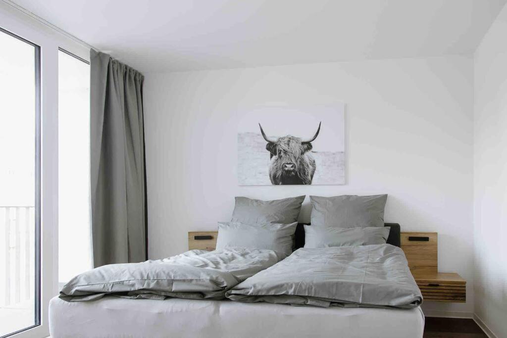 a bedroom with a bed with a bull head on the wall at Gropius in Dessau