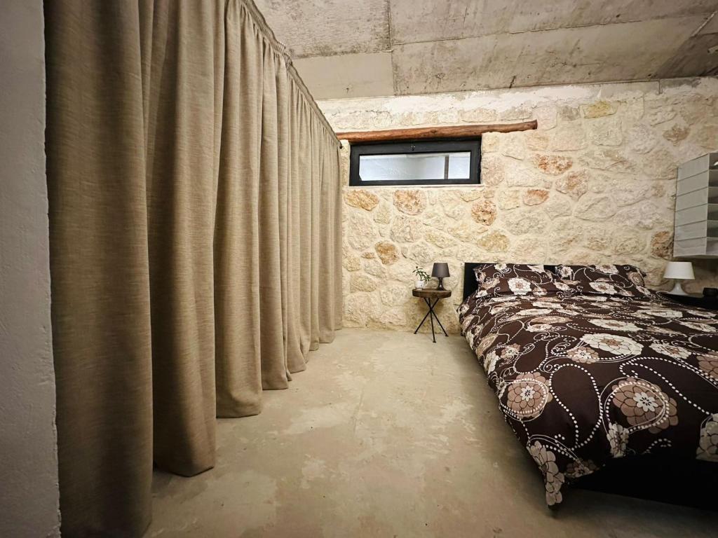 a bedroom with a bed with curtains in it at The Hermitage: Timeless charm&Beach&History nearby in Yenibosazici