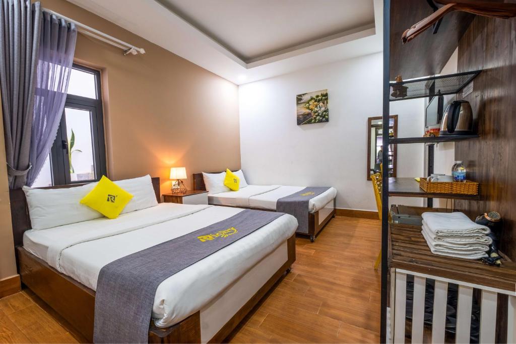 Posteľ alebo postele v izbe v ubytovaní Richy Dalat Hotel