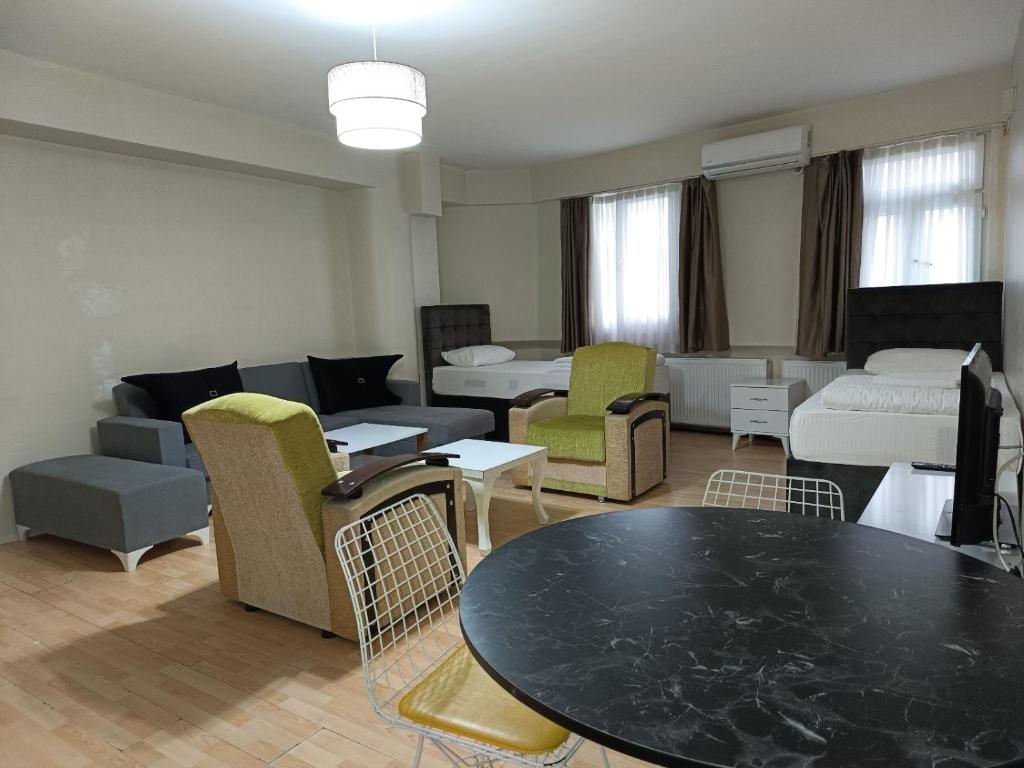 sala de estar con sofá, mesa y sillas en White Crown Apartman ve Yaşam Merkezi, en Estambul