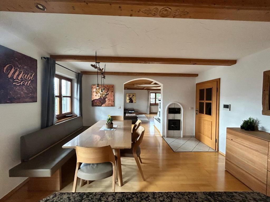 a kitchen and dining room with a table and chairs at Habicht Ferienhaus in Arnbruck