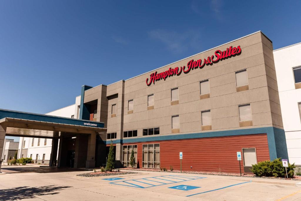 a building with a sign on the side of it at Hampton Inn & Suites Scottsbluff in Scottsbluff