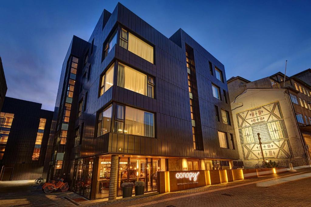 a building on a city street at night at Canopy by Hilton Reykjavik City Centre in Reykjavík