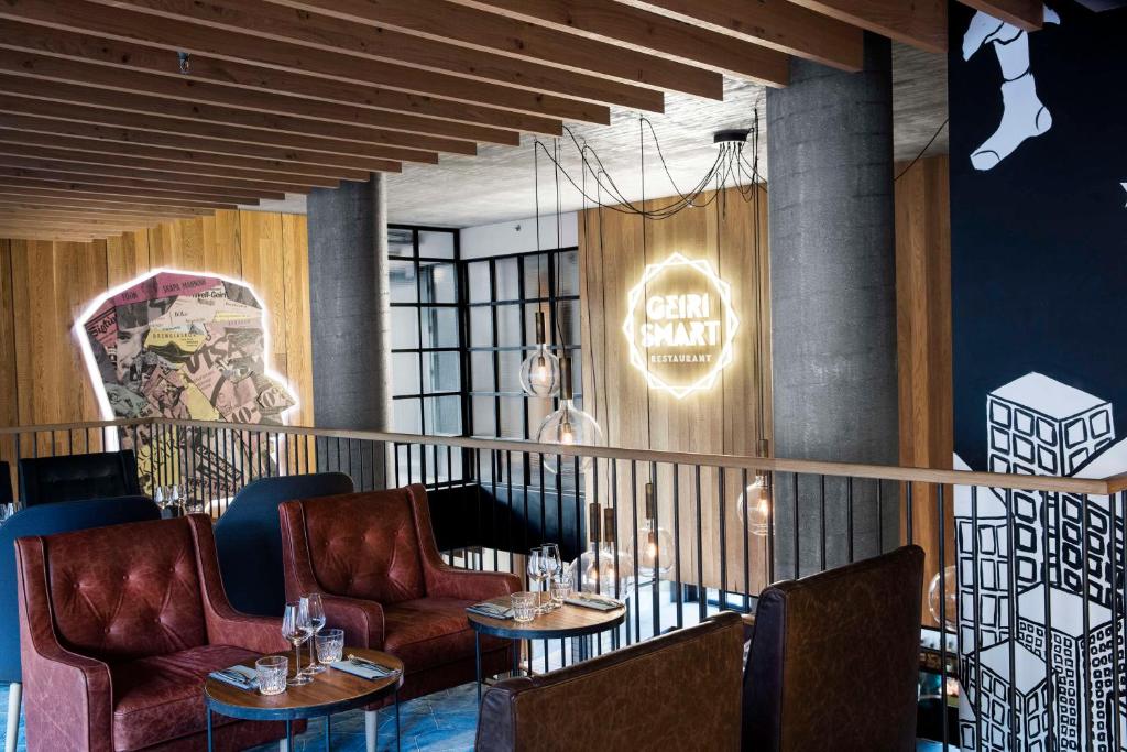 a restaurant with chairs and tables and a sign that says calm sanctuary at Canopy by Hilton Reykjavik City Centre in Reykjavík