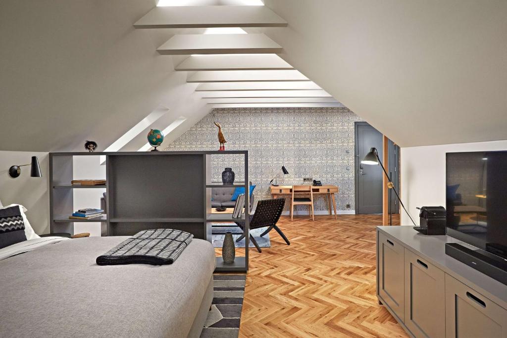 a bedroom with a bed and a desk with a computer at Canopy by Hilton Reykjavik City Centre in Reykjavík