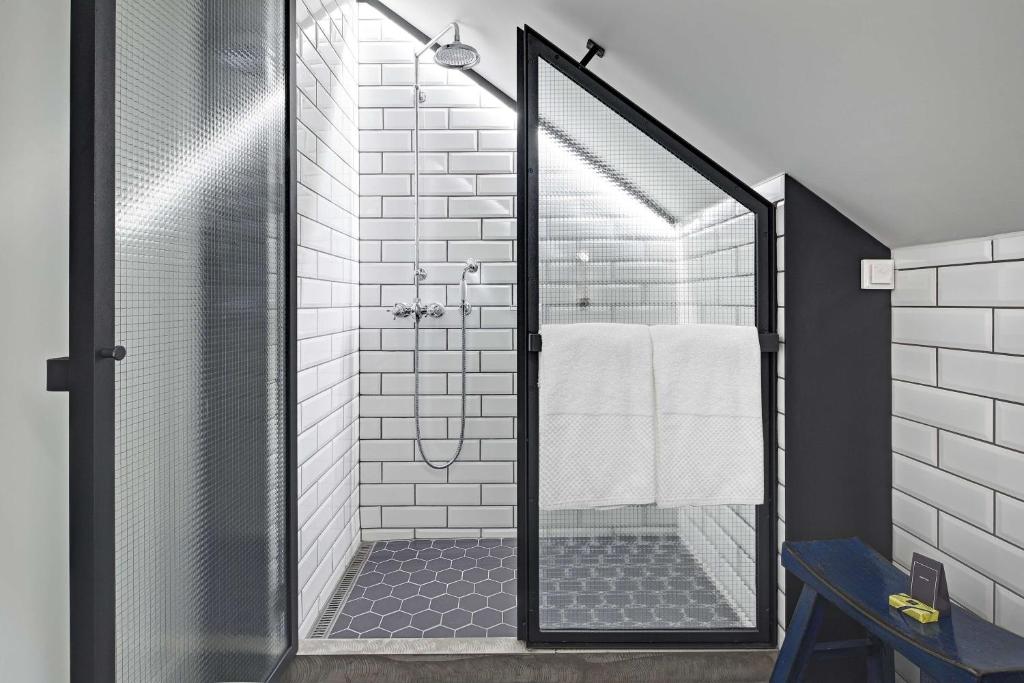 a shower with a glass door in a bathroom at Canopy by Hilton Reykjavik City Centre in Reykjavík