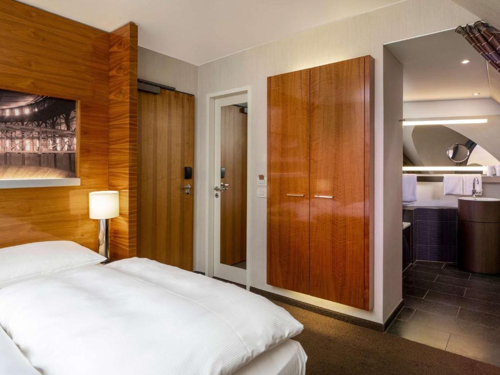 Postel nebo postele na pokoji v ubytování Mövenpick Hotel Hamburg City