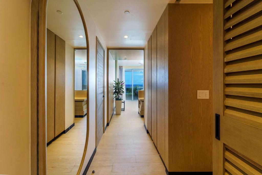 a hallway of a house with wooden floors and a mirror at Wyndham Grand Barbados Sam Lords Castle All Inclusive Resort in Saint Philip