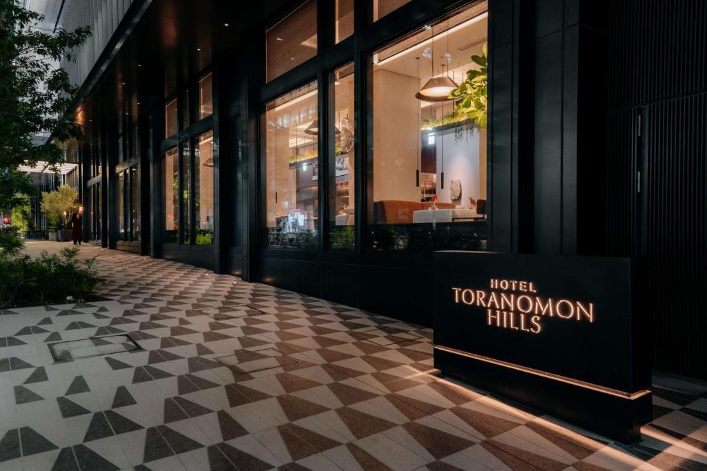 a store front with a sign on the sidewalk at Hotel Toranomon Hills, The Unbound Collection By Hyatt in Tokyo