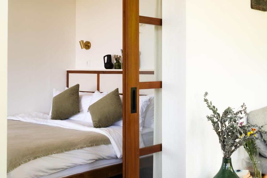 a bedroom with a bunk bed with white sheets at The Birdhouse Uluwatu 2BR Treetop Private Home with Deep Plunge Pool in Uluwatu
