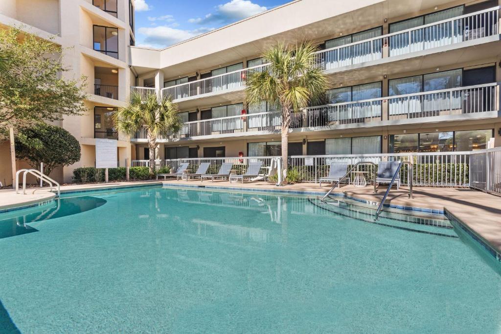 a swimming pool in front of a building at Spark by Hilton Hilton Head Island in Hilton Head Island