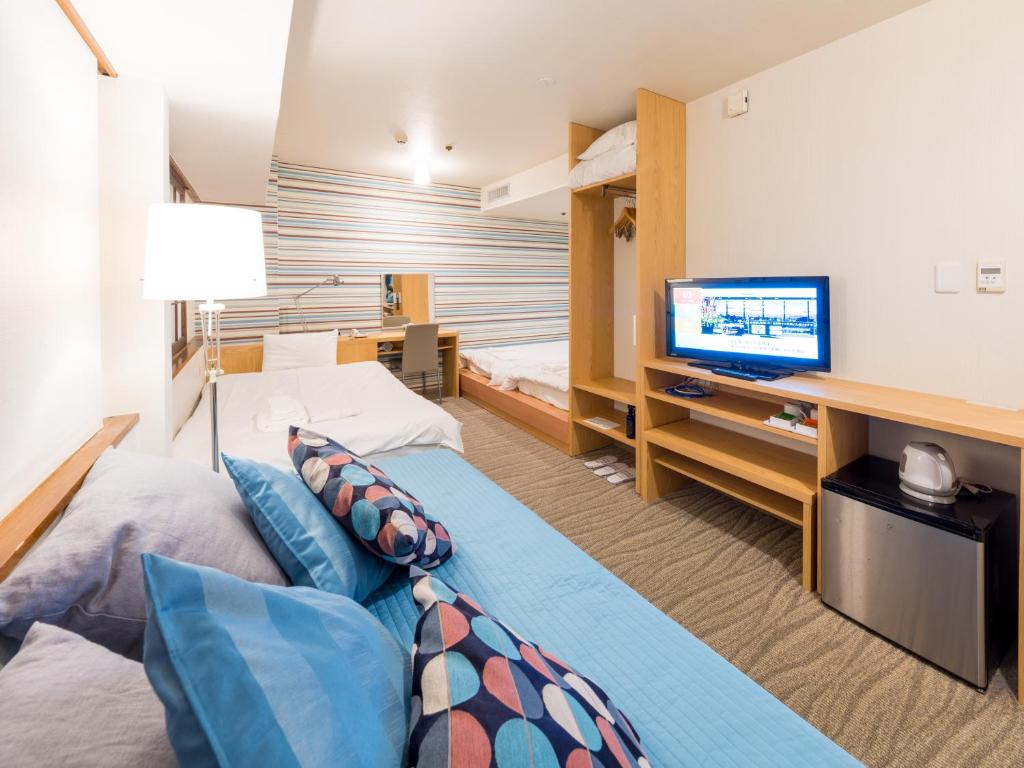 TV a/nebo společenská místnost v ubytování New Osaka Hotel