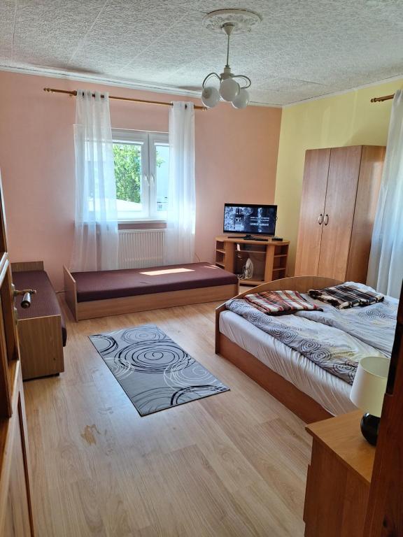 a bedroom with a large bed and a window at Mieszkanie Dalia in Karwia