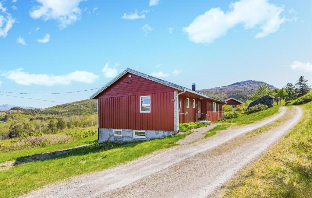 a red barn on the side of a dirt road at Amazing Home In Leines With House Sea View in Leines