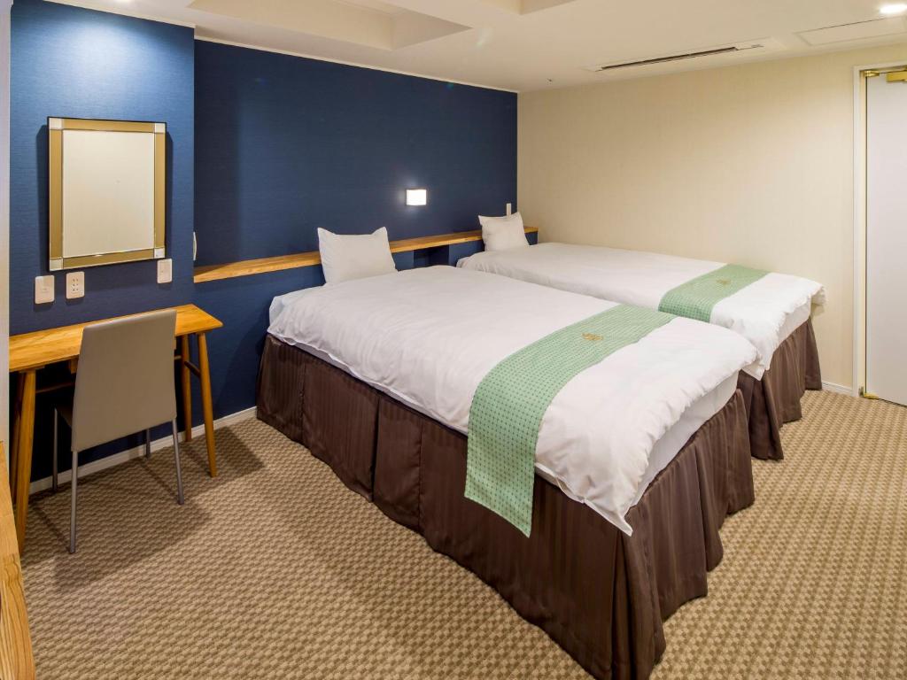 Postel nebo postele na pokoji v ubytování New Osaka Hotel