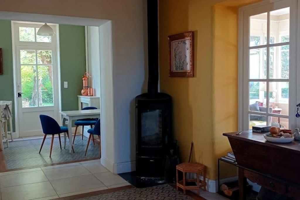 a living room with a wood stove in it at Maison de maître parc privé proche Crest et Drôme. in Crest