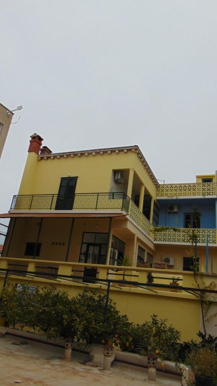a large yellow building with a balcony on it at Marina in Vela Luka