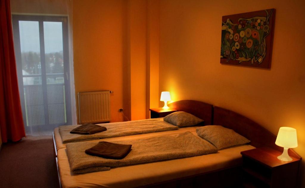 a bedroom with a bed with two pillows on it at Hotel Kreator-Sport in Krakow