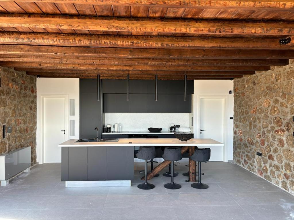 a kitchen with a table and chairs in a room at Heartbeat Mountain Escapes in Kato Trikala Korinthias