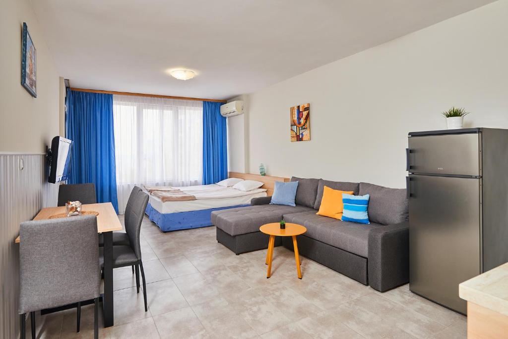 a living room with a couch and a bed at Студио Калина in Pomorie