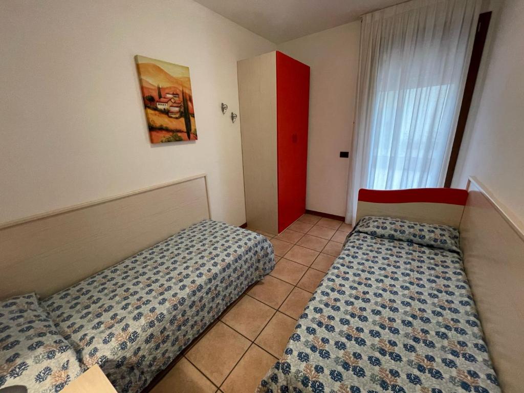 A bed or beds in a room at Villaggio ai Ginepri - Agenzia Cocal