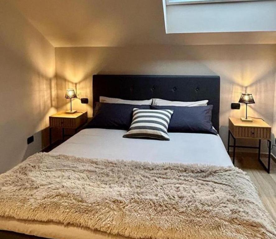 una camera con un grande letto con due lampade di 12zero38 a Savigliano