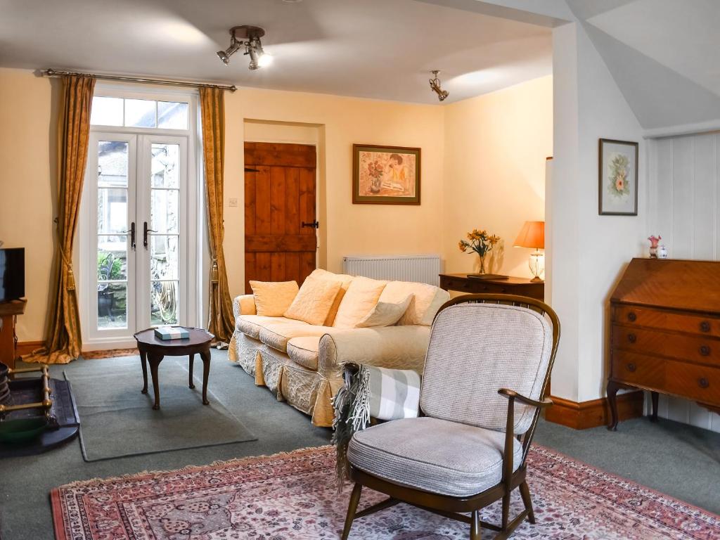 a living room with a couch and a chair at Beech Cottage in Carnforth