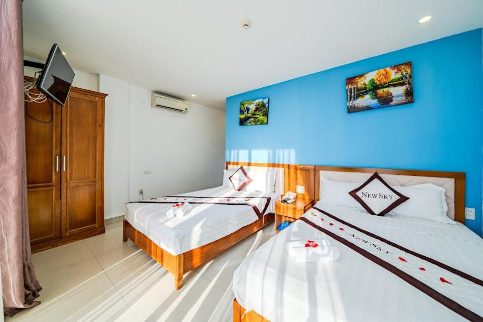 Postel nebo postele na pokoji v ubytování New Sky Hotel